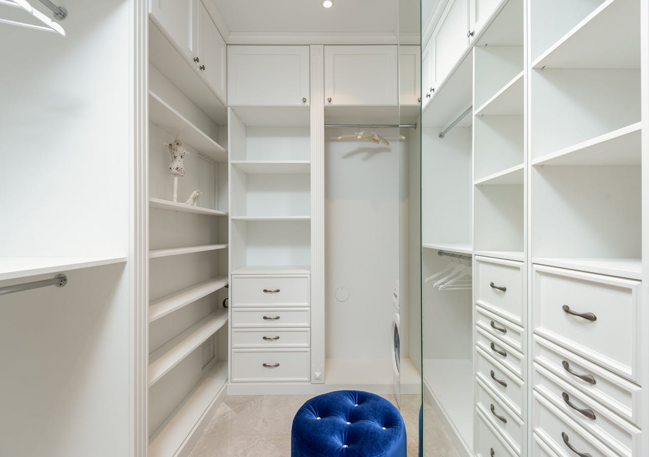 Elegant white walk-in closet with ample storage and modern design